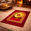 Luxury red velvet prayer mat with gold Islamic arch design placed in a cozy living room setting